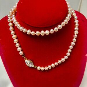 Pink strand of  fresh water pearl necklace with gold plated CZ clasp.